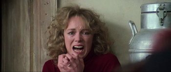 Movie still from “The House by the Cemetery” (1981), directed by Lucio Fulci – A person holding their hands to their mouth; Close Up shot, High angle