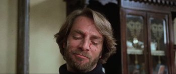 Movie still from “The House by the Cemetery” (1981), directed by Lucio Fulci – A person with blood on his face; Close Up shot, Low angle