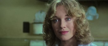 Movie still from “The House by the Cemetery” (1981), directed by Lucio Fulci – A person with curly blonde hair; Close Up shot, Over the shoulder angle