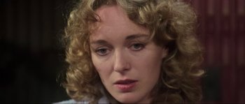 Movie still from “The House by the Cemetery” (1981), directed by Lucio Fulci – A person with curly blonde hair; Close Up shot, High angle