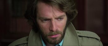 Movie still from “The House by the Cemetery” (1981), directed by Lucio Fulci – A person with a beard; Close Up shot, Over the shoulder angle