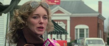 Movie still from “The House by the Cemetery” (1981), directed by Lucio Fulci – A person wearing sunglasses and holding a box; Close Up shot, Low angle