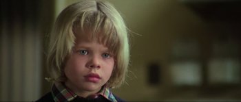 Movie still from “The House by the Cemetery” (1981), directed by Lucio Fulci – A young child's face with blue eyes; Close Up shot, Low angle