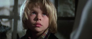 Movie still from “The House by the Cemetery” (1981), directed by Lucio Fulci – A young child's face with blue eyes; Close Up shot, Low angle