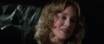 Movie still from “The House by the Cemetery” (1981), directed by Lucio Fulci – A person with curly hair; Close Up shot, Over the shoulder angle
