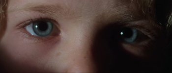 Movie still from “The House by the Cemetery” (1981), directed by Lucio Fulci – A person's eye with a light in it; Extreme Close Up shot, Overhead angle