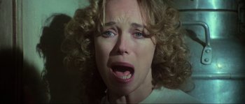 Movie still from “The House by the Cemetery” (1981), directed by Lucio Fulci – A person with curly hair; Close Up shot, Low angle