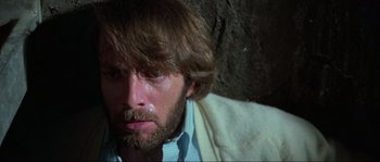 Movie still from “The House by the Cemetery” (1981), directed by Lucio Fulci – A person with a beard; Close Up shot, Low angle
