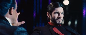 Movie still from “The Hunger Games” (2012), directed by Gary Ross – A person wearing a suit and tie; Close Up shot, Low angle