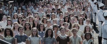 Movie still from “The Hunger Games” (2012), directed by Gary Ross – A large group of people standing in a crowd; Wide shot, High angle