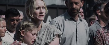 Movie still from “The Hunger Games” (2012), directed by Gary Ross – A man and a woman standing next to each other; Close Up shot, Over the shoulder angle