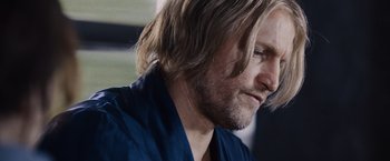 Movie still from “The Hunger Games” (2012), directed by Gary Ross – A person with long blonde hair; Close Up shot, Over the shoulder angle