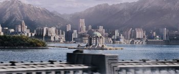 Movie still from “The Hunger Games” (2012), directed by Gary Ross – A view of a city from across a body of water; Extreme Wide shot, High angle