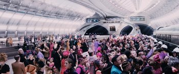 Movie still from “The Hunger Games” (2012), directed by Gary Ross – A large crowd of people in a train station; Extreme Wide shot, High angle