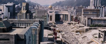 Movie still from “The Hunger Games” (2012), directed by Gary Ross – An aerial view of a city with a lot of people walking on it; Extreme Wide shot, High angle