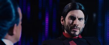 Movie still from “The Hunger Games” (2012), directed by Gary Ross – A person wearing a suit and tie; Close Up shot, Low angle