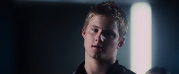 Movie still from “The Hunger Games” (2012), directed by Gary Ross – A young man is looking into the distance; Close Up shot, Low angle