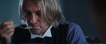 Movie still from “The Hunger Games” (2012), directed by Gary Ross – A person with long blond hair; Close Up shot, Low angle