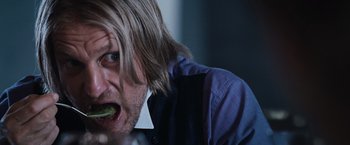 Movie still from “The Hunger Games” (2012), directed by Gary Ross – A person with long blonde hair; Close Up shot, Over the shoulder angle