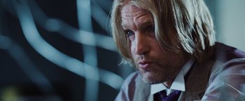 Movie still from “The Hunger Games” (2012), directed by Gary Ross – A person with long blonde hair; Close Up shot, Over the shoulder angle