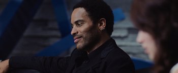 Movie still from “The Hunger Games” (2012), directed by Gary Ross – A person wearing a suit and tie; Close Up shot, Low angle