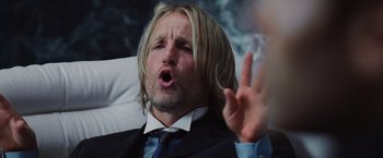 Movie still from “The Hunger Games” (2012), directed by Gary Ross – A person wearing a suit and tie; Close Up shot, Low angle
