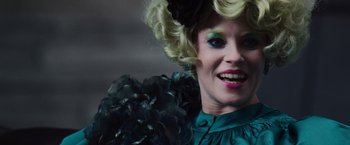 Movie still from “The Hunger Games” (2012), directed by Gary Ross – A person wearing a costume; Close Up shot, Over the shoulder angle