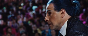 Movie still from “The Hunger Games” (2012), directed by Gary Ross – A person wearing a suit and tie; Close Up shot, Over the shoulder angle
