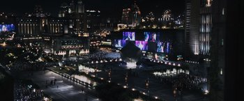Movie still from “The Hunger Games” (2012), directed by Gary Ross – An aerial view of a city at night with lights; Extreme Wide shot, High angle