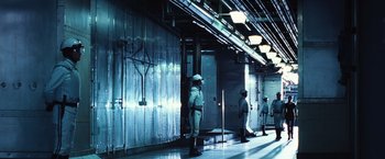 Movie still from “The Hunger Games” (2012), directed by Gary Ross – A group of men standing next to each other in a building; Extreme Wide shot, Low angle