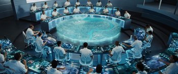 Movie still from “The Hunger Games” (2012), directed by Gary Ross – A group of people sitting around a table; Wide shot, High angle