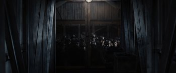 Movie still from “The Hunger Games” (2012), directed by Gary Ross – A group of people standing in front of a building; Wide shot, High angle