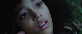 Movie still from “The Hunger Games” (2012), directed by Gary Ross – A woman's face with white teeth; Close Up shot, Overhead angle