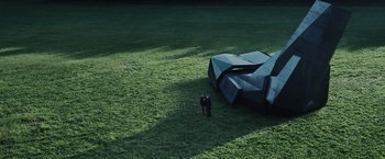 Movie still from “The Hunger Games” (2012), directed by Gary Ross – A man standing in a field next to an object; Extreme Wide shot, High angle