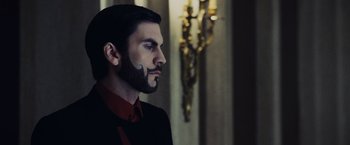 Movie still from “The Hunger Games” (2012), directed by Gary Ross – A man with a long beard and a mustache; Close Up shot, Low angle