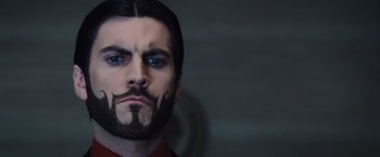 Movie still from “The Hunger Games” (2012), directed by Gary Ross – A person with a beard; Close Up shot, Low angle