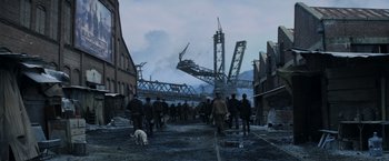 Movie still from “The Hunger Games: Catching Fire” (2013), directed by Francis Lawrence – A group of people standing on top of a dirt road; Extreme Wide shot, High angle