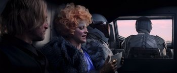 Movie still from “The Hunger Games: Catching Fire” (2013), directed by Francis Lawrence – A woman in a blue dress and a man in a silver suit; Close Up shot, Over the shoulder angle