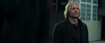 Movie still from “The Hunger Games: Catching Fire” (2013), directed by Francis Lawrence – A man with blonde hair wearing a black coat; Close Up shot, Low angle