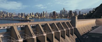 Movie still from “The Hunger Games: Catching Fire” (2013), directed by Francis Lawrence – A view of a city from a bridge over a river; Extreme Wide shot, High angle