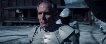 Movie still from “The Hunger Games: Catching Fire” (2013), directed by Francis Lawrence – A person wearing armor; Close Up shot, Over the shoulder angle