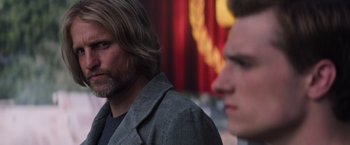 Movie still from “The Hunger Games: Catching Fire” (2013), directed by Francis Lawrence – A man with long hair and a beard and a man with long hair; Close Up shot, Over the shoulder angle