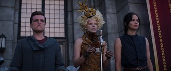 Movie still from “The Hunger Games: Catching Fire” (2013), directed by Francis Lawrence – A woman with blonde hair wearing a butterfly dress; Medium shot, Low angle