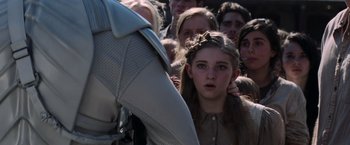 Movie still from “The Hunger Games: Catching Fire” (2013), directed by Francis Lawrence – A group of people standing around a crowd of people; Close Up shot, Over the shoulder angle