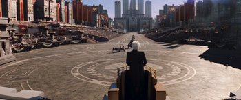 Movie still from “The Hunger Games: Catching Fire” (2013), directed by Francis Lawrence – An old man riding a horse drawn carriage down a street; Extreme Wide shot, High angle