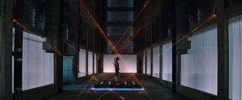 Movie still from “The Hunger Games: Catching Fire” (2013), directed by Francis Lawrence – A person standing in a room with lights on the ground; Extreme Wide shot, Low angle