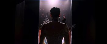 Movie still from “The Hunger Games: Catching Fire” (2013), directed by Francis Lawrence – A woman is standing in front of a mirror; Wide shot, Low angle