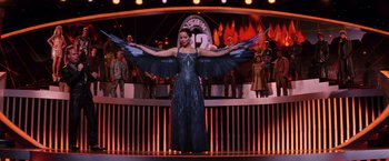 Movie still from “The Hunger Games: Catching Fire” (2013), directed by Francis Lawrence – A woman dressed as katniss everdeen from the hunger games; Wide shot, Low angle