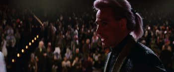 Movie still from “The Hunger Games: Catching Fire” (2013), directed by Francis Lawrence – A man in a crowd of onlookers is looking into the distance; Close Up shot, Low angle