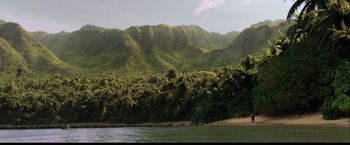 Movie still from “The Hunger Games: Catching Fire” (2013), directed by Francis Lawrence – A view of a lush green mountain range from the water; Extreme Wide shot, High angle